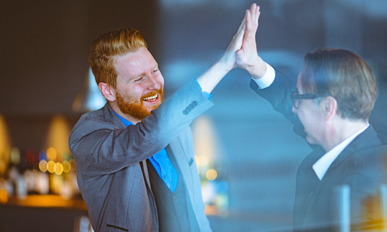 Two men giving each other a high five