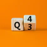 Two wooden blocks showing Q3 is turning into Q4