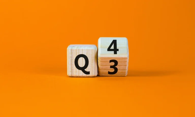 Two wooden blocks showing Q3 is turning into Q4