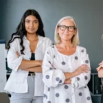 A group of women standing with their arms folded
