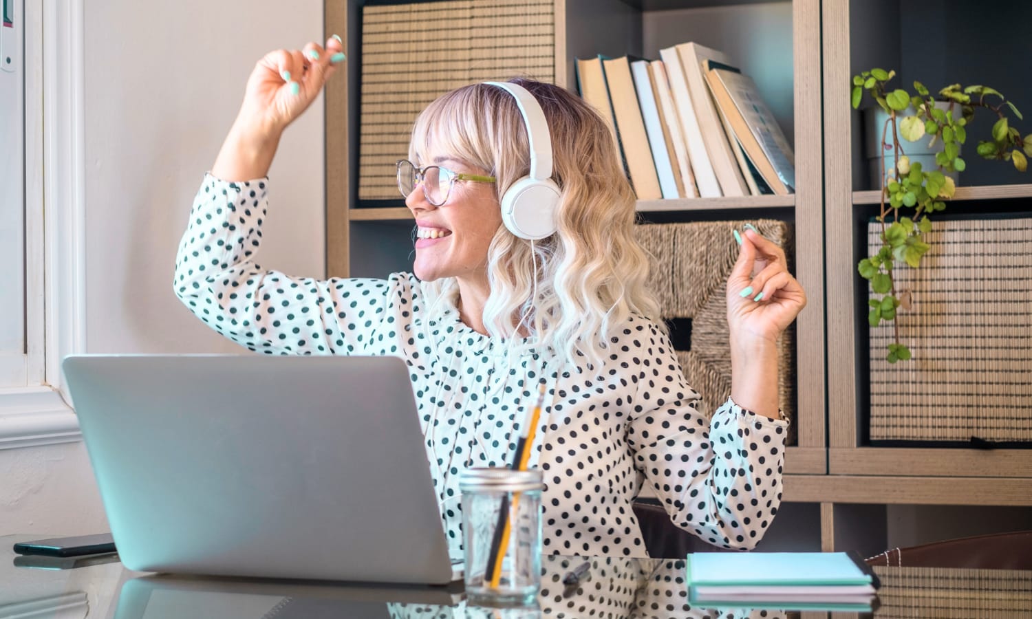 A woman dancing at her desk