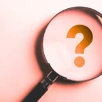 A magnifying glass focusing on a question mark