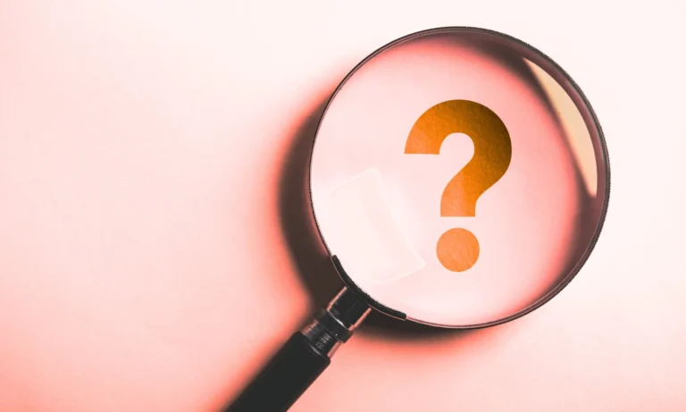 A magnifying glass focusing on a question mark