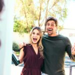 A couple arriving at a house as guests