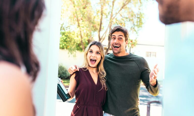 A couple arriving at a house as guests