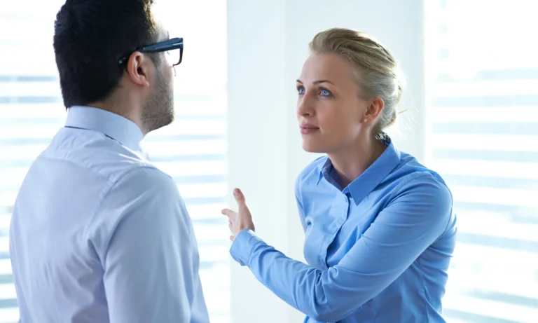 A woman having a conflict with a man in an office environment