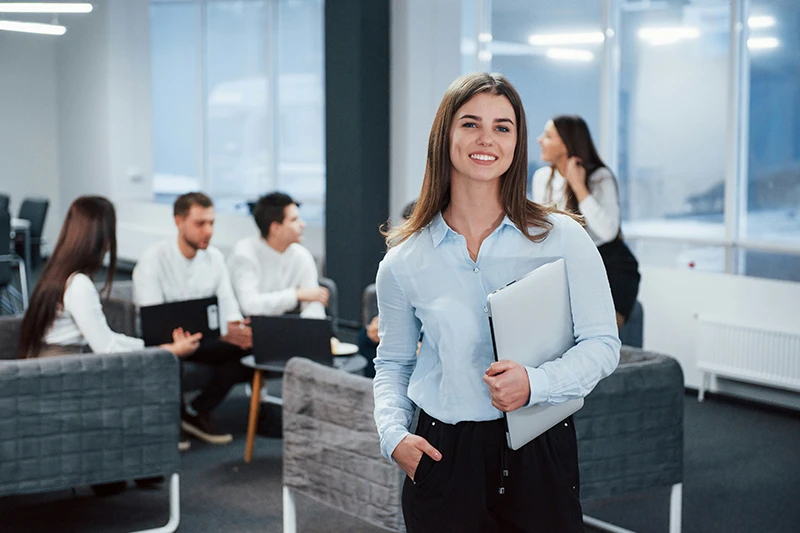 A woman in an office with her staff