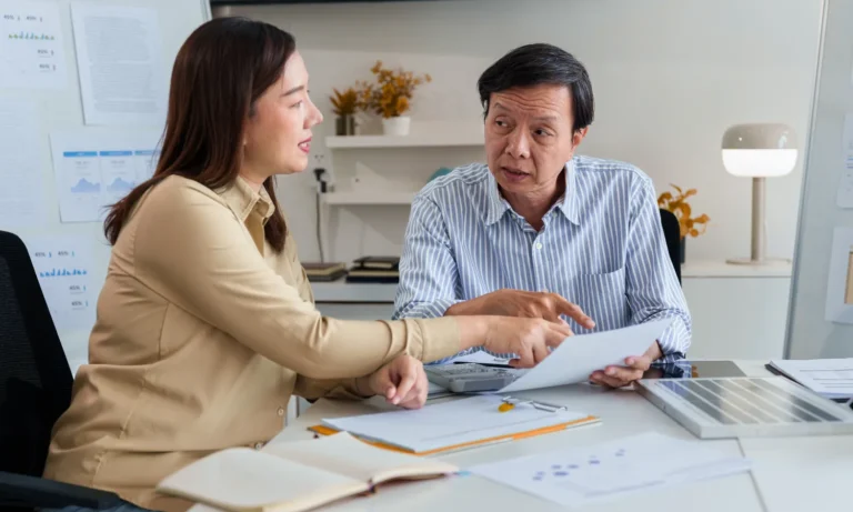 A woman and a man meeting in an office setting